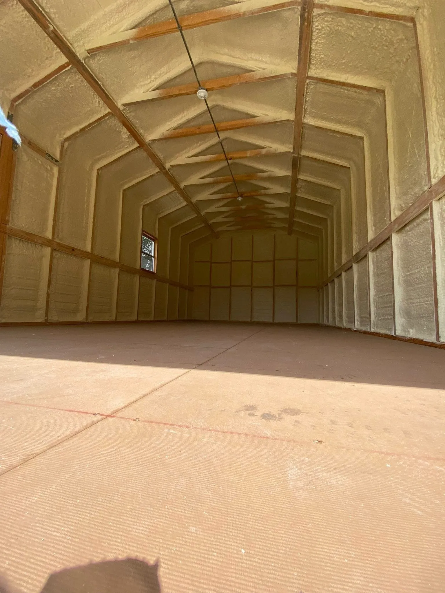 What makes spray foam more effective than traditional fiberglass batts